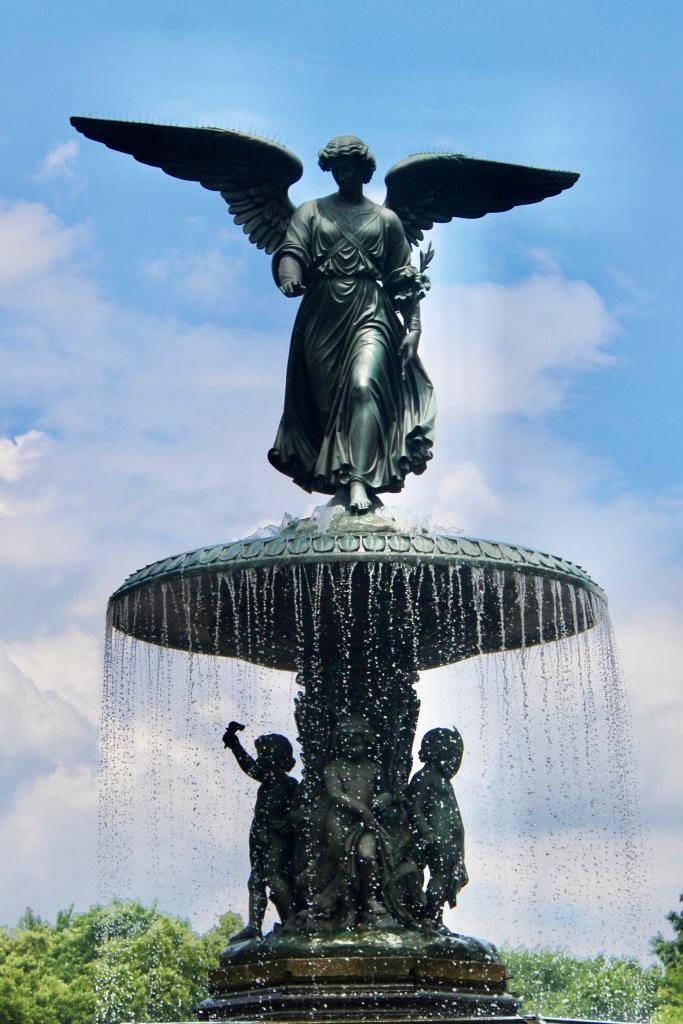 a water fountain with angels